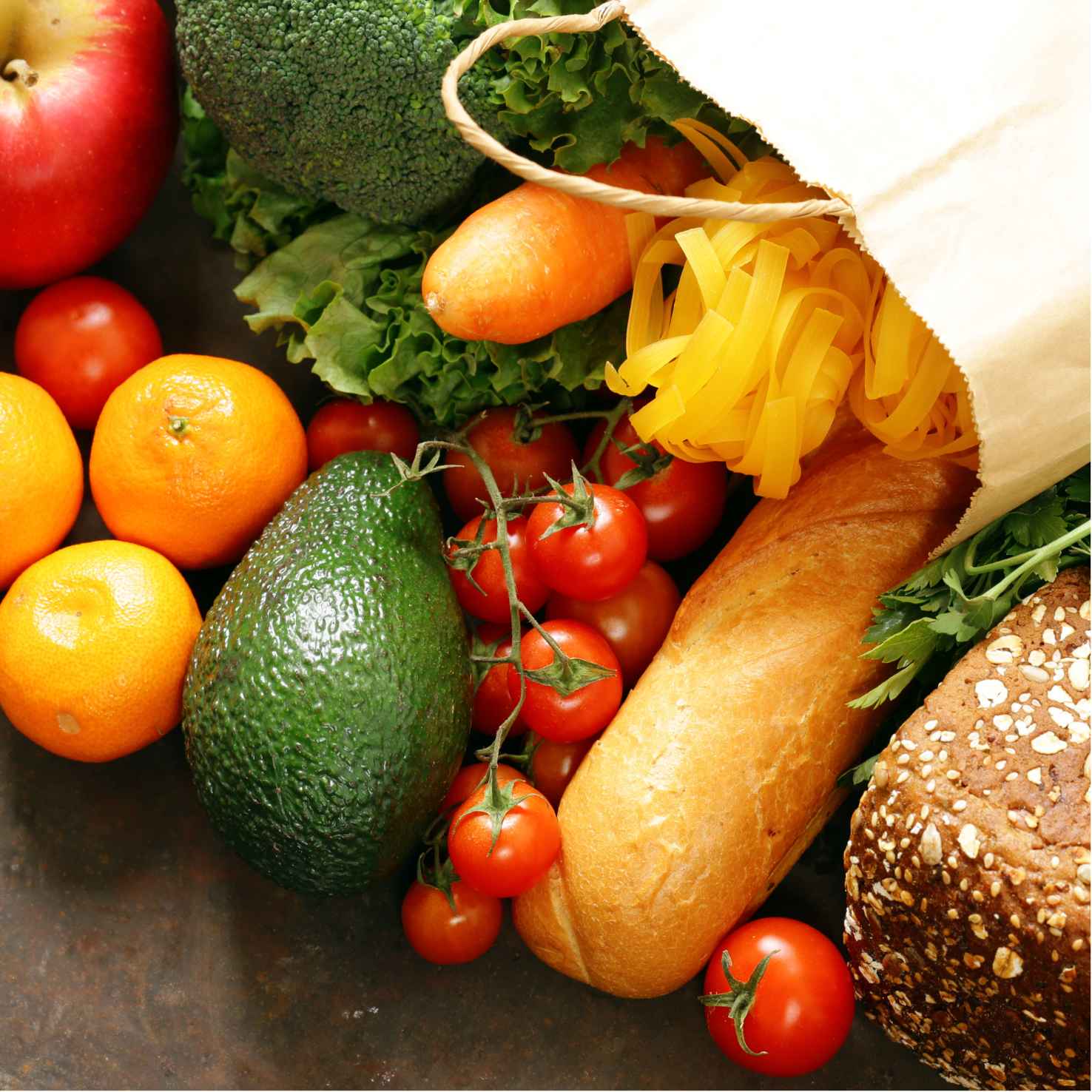 . A vibrant bag containing bread, assorted veggies, and fruits, ideal for a corporate catering setup